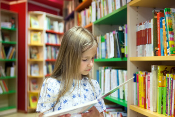 girl reading   book in     library.