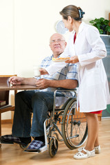 Fototapeta premium wife helping her husband in wheelchair.