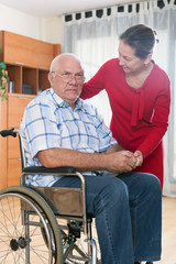 Fototapeta na wymiar wife next to sad husband in wheelchair