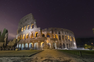Fototapeta na wymiar Beautiful night view with stars of Colosseum in Rome, Italy
