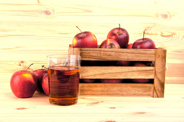 Red apples on table in wooden crate, pile of fresh apple .