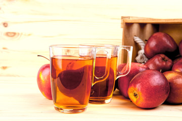 Red apples on table in wooden crate, pile of fresh apple .
