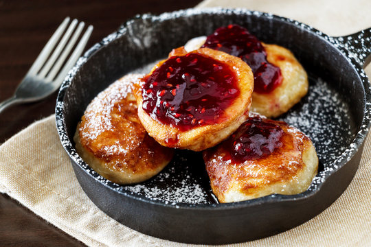 Pancakes with Raspberry jam in cast-iron frying pan
