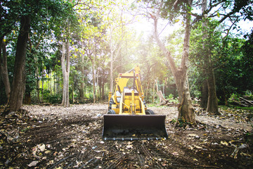 Yellow tractor parked in the construction site