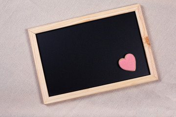 Valentine background and pink cookie on slate blackboard. Ideas for valentine's love concept.