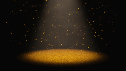 twinkling golden glitter falling through a cone of light on a stage 