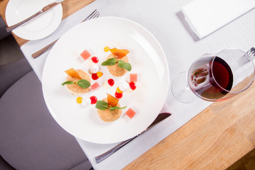 Plum dumplings with cinnamon, white chocolate and vanilla sauce served in a restaurant