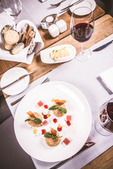 Plum dumplings with cinnamon, white chocolate and vanilla sauce served in a restaurant