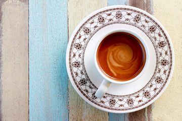 Cappuccino coffee in white cup on wood desktops.