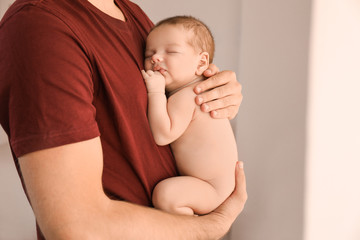 Father with cute little baby at home