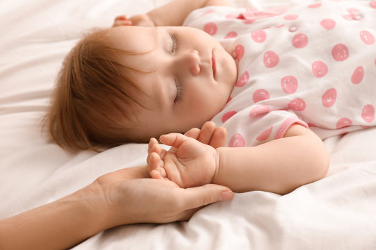 Mother holding her baby's hand, closeup