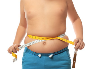 Overweight boy measuring his waist on white background, closeup