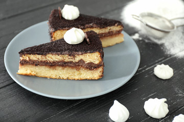 Plate with tasty chocolate cakes on wooden background