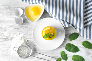 Composition with tasty fruit cake on wooden background