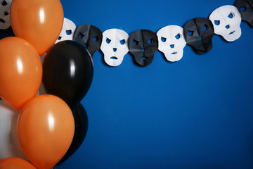 Creative decor for Halloween party on color background