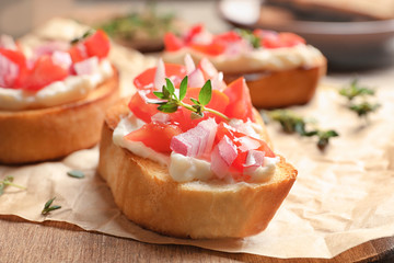 Tasty fresh bruschetta on wooden board, closeup