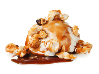 Ice cream ball with caramel sauce and popcorn on white background