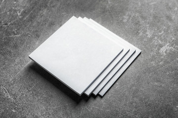Blank sheets of paper on grey background. Mock up for design