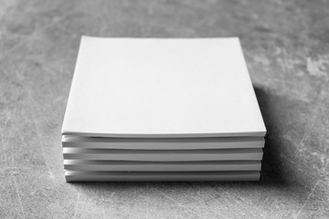 Blank sheets of paper on grey background. Mock up for design