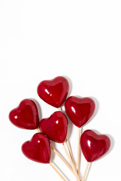decorative hearts on sticks on a white background, vertical closeup