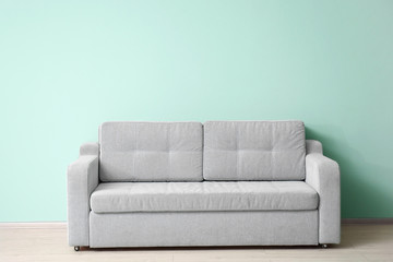 Soft sofa near color wall