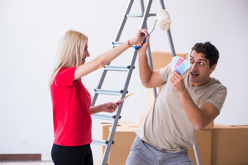 Young family doing painting job during home renovation