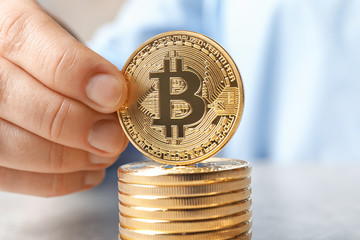 Hand with golden bitcoins, closeup