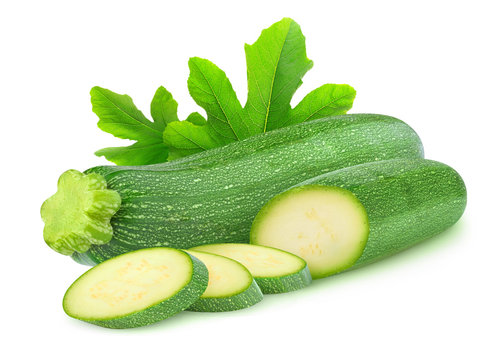 Isolated courgettes. One whole and sliced zucchini fruits isolated on white background with clipping path