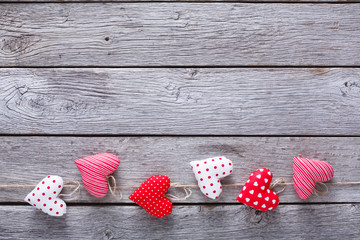 Valentine day background, pillow hearts border on wood