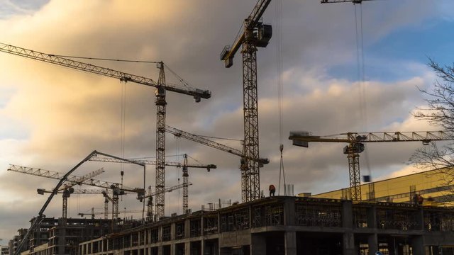 Cranes working on construction of the housing estate in former industrial zone. time lapse