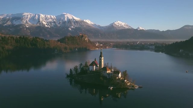 bled lake aerial view flying around the island at sunrise