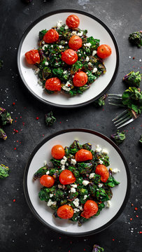 Homemade Roasted Green Kalettes salad with cherry tomatoes and feta cheese. healthy food