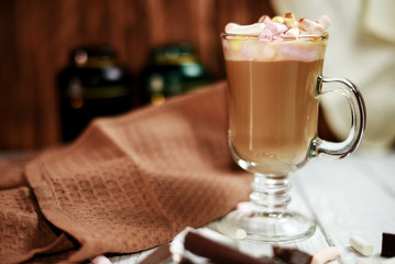 Glass cup of cappuccino on wooden table