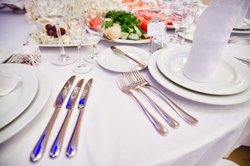 Knives and forks on the table, table laying