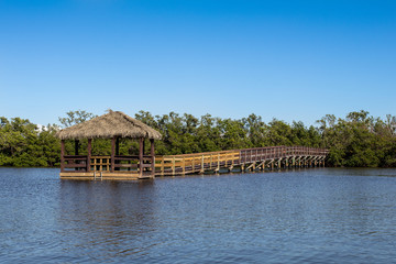 Boardwalk and Tiki Hut Over the Water - 188098384