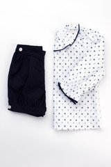 Pajama set for little girl. White jacket with anchor and handwheel pattern. Plain dark blue shorts.