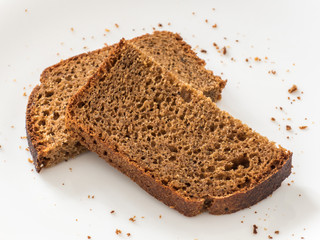 Two piece of black rye bread on white background