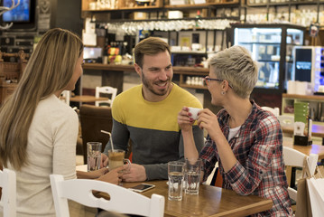 Friends having a great time in a coffee shop.
