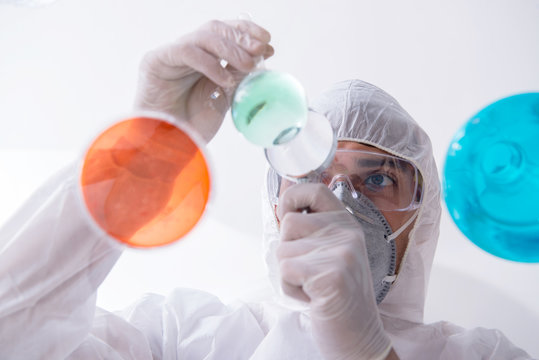 Chemist working in the laboratory with hazardous chemicals 