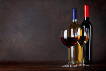Fototapeta na wymiar Red and white wine bottles and glasses