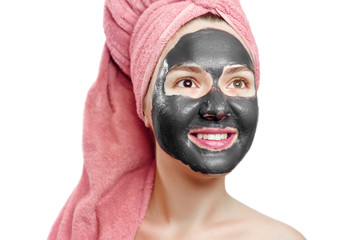 beautiful pretty sexy girl with black face mask on the white background,  close-up portrait, isolated, girl with a pink towel on her head, girl is smiling, black mask on girl's face, enjoys