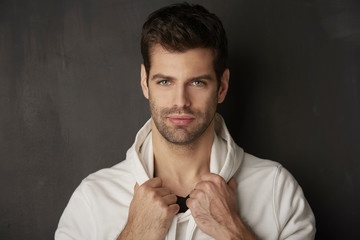 Obraz premium Handsome young man. Studio portrait against dark background.