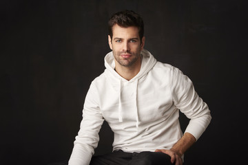 Handsome young man. Studio portrait against dark background.