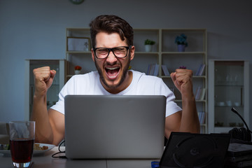 Young man staying late in office to do overtime work