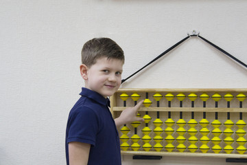 Mental arithmetic school. Boy counts with abacus in `soroban` class. Japanese abacus. Concept of back to school.copy space.