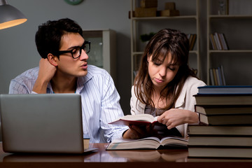 Two students studying late preparing for exams