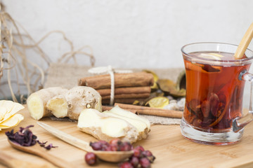 Healthy herbal tea,  spiced tea over wood background 