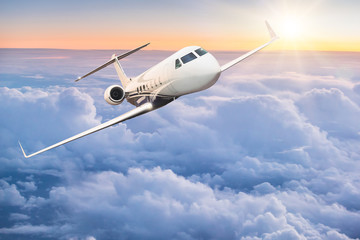 Commercial airplane flying above clouds.