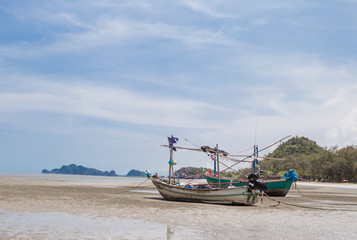 Naklejka na ściany i meble Old fishing boat on a beach