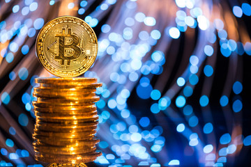 Bitcoin gold coins with defocused abstract background. Virtual cryptocurrency concept.